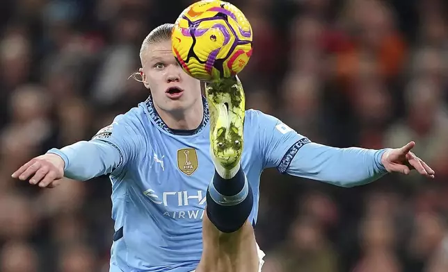 Manchester City's Erling Haaland contols the ball during the English Premier League soccer match between Liverpool and Manchester City at Anfield Stadium, Liverpool, England, Sunday Dec. 1, 2024. (Peter Byrne/PA via AP)