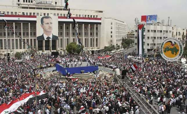 FILE.- Pro-Syrian government demonstrators hold a rally at Sabe Bahrat Square to commemorate the 65th anniversary of the foundation of the Ruling Baath Arab Socialist Party in Damascus, Syria, Saturday, April 7, 2012. (AP Photo/Bassem Tellawi,File)