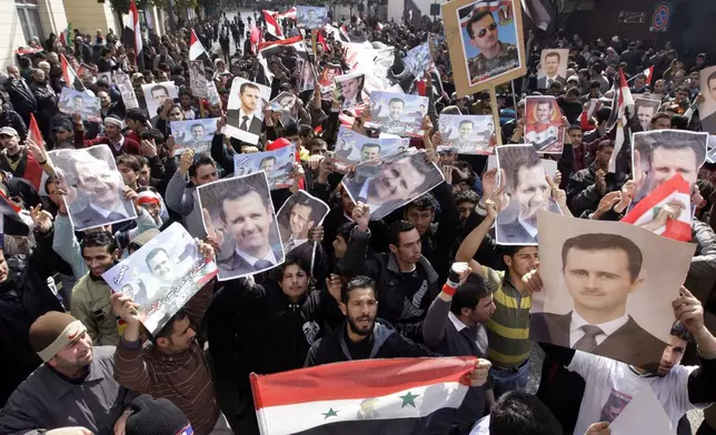 FILE.- Syrian Baath Party supporters chant slogans, as they carry Syrian flags and portraits of Syrian President Bashar Assad in support of Assad in Beirut, Lebanon, Sunday March 4, 2012. (AP Photo/Bilal Hussein,File)