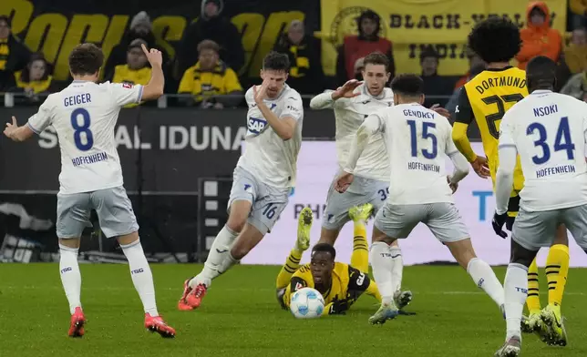 Dortmund's Jamie Bynoe-Gittens falls on the ground during the German Bundesliga soccer match between Borussia Dortmund and TSG Hoffenheim at the Signal-Iduna Park in Dortmund, Germany, Sunday, Dec. 15 2024. (AP Photo/Martin Meissner)