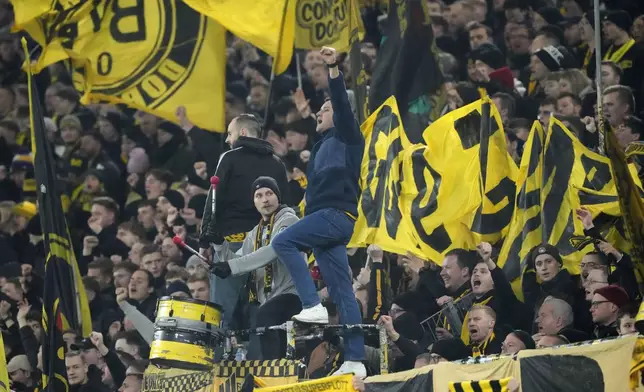 Dortmund supporters cheer for their team during the German Bundesliga soccer match between Borussia Dortmund and TSG Hoffenheim at the Signal-Iduna Park in Dortmund, Germany, Sunday, Dec. 15 2024. (AP Photo/Martin Meissner)