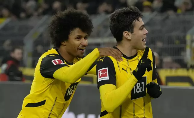 Dortmund's Giovanni Reyna, right, celebrates with teammate Karim Adeyemi after scoring the opening goal during the German Bundesliga soccer match between Borussia Dortmund and TSG Hoffenheim at the Signal-Iduna Park in Dortmund, Germany, Sunday, Dec. 15 2024. (AP Photo/Martin Meissner)