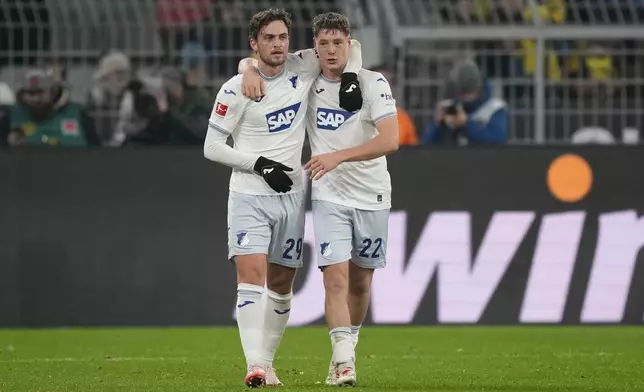 Hoffenheim's Jacob Bruun Larsen, left, celebrates with teammate Alexander Prass after scoring his side's first goal during the German Bundesliga soccer match between Borussia Dortmund and TSG Hoffenheim at the Signal-Iduna Park in Dortmund, Germany, Sunday, Dec. 15 2024. (AP Photo/Martin Meissner)