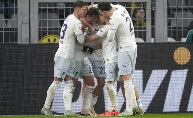 Hoffenheim's Jacob Bruun Larsen, second left, celebrates with teammates after scoring his side's first goal during the German Bundesliga soccer match between Borussia Dortmund and TSG Hoffenheim at the Signal-Iduna Park in Dortmund, Germany, Sunday, Dec. 15 2024. (AP Photo/Martin Meissner)