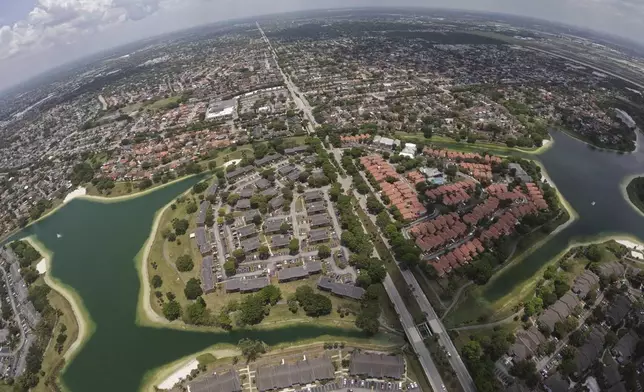 Housing developments are seen amid artificial lakes on the western side of Miami, Friday, May 17, 2024, during a flight donated by LightHawk over parts of the vast Everglades ecosystem in southern Florida. (AP Photo/Rebecca Blackwell)