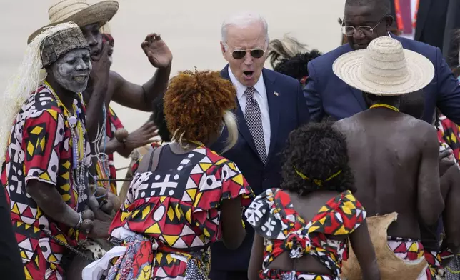 President Joe Biden watches a traditional dance after arriving at Catumbela airport in Angola on Wednesday, Dec. 4, 2024. (AP Photo/Ben Curtis)