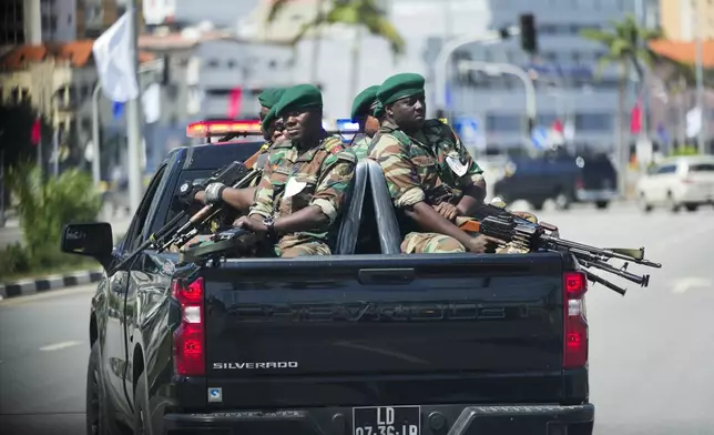 Angolan soldiers escort the motorcade of President Joe Biden in Luanda, Angola, on Wednesday, Dec. 4, 2024. (AP Photo/Ben Curtis)