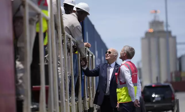 President Joe Biden and Chief Operating Officer of Lobito Atlantic Railway Nicolas Gregoire meet rail workers during the tour of the Lobito Port Terminal in Lobito, Angola, on Wednesday, Dec. 4, 2024. (AP Photo/Ben Curtis)