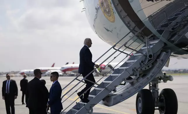 President Joe Biden boards Air Force One at Quatro de Fevereiro International Airport in Luanda, Angola, on Wednesday, Dec. 4, 2024. (AP Photo/Ben Curtis)