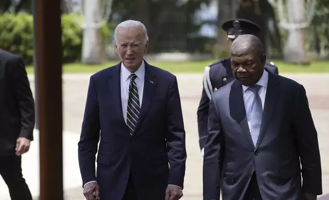 President Joe Biden walks with Angola's President Joao Lourenco, at the presidential palace in the capital Luanda, Angola on Tuesday, Dec. 3, 2024. (AP Photo/Ben Curtis)