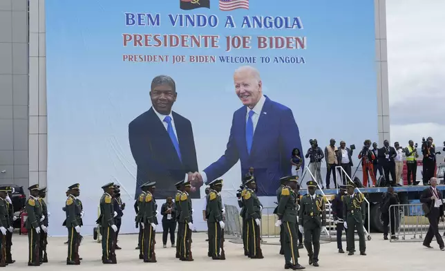 A poster showing President Joe Biden and Angola's President Joao Lourenco is seen during a welcome ceremony at Catumbela airport in Angola on Wednesday, Dec. 4, 2024. (AP Photo/Ben Curtis)