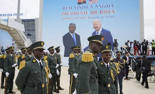 A poster showing President Joe Biden and Angola's President Joao Lourenco is seen during a welcome ceremony at Catumbela airport in Angola on Wednesday, Dec. 4, 2024. (AP Photo/Ben Curtis)