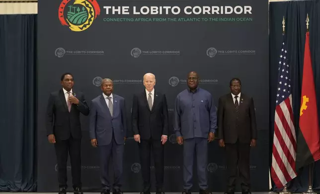 From the left, Zambia President Hakainde Hichilema, Angola's President Joao Lourenco, President Joe Biden, President Felix Tshisekedi of the Democratic Republic of the Congo, and Vice President of Tanzania Philip Isdor Mpango pose for a photo during the visit to the Carrinho food processing factory near Lobito, Angola on Wednesday, Dec. 4, 2024. (AP Photo/Ben Curtis)