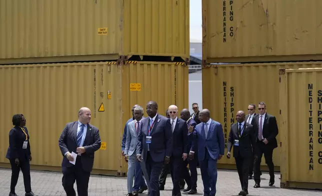 President Joe Biden, center, and Angola's President Joao Lourenco, right, tour the Lobito Port Terminal in Lobito, Angola, on Wednesday, Dec. 4, 2024. (AP Photo/Ben Curtis)