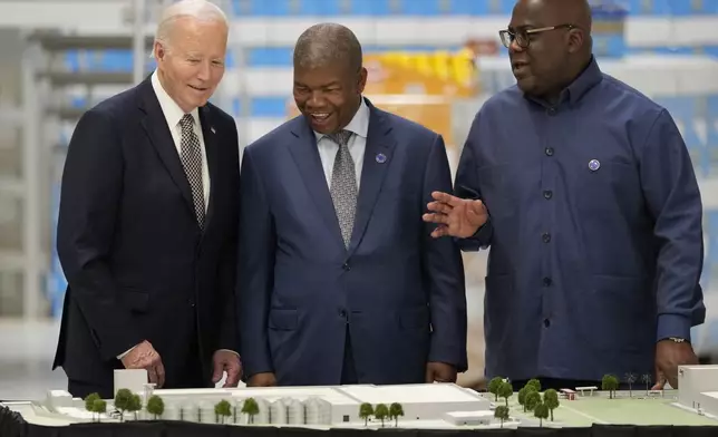 President Joe Biden, accompanied by Angola's President Joao Lourenco, center, and President Felix Tshisekedi of the Democratic Republic of the Congo visits the Carrinho food processing factory near Lobito, Angola on Wednesday, Dec. 4, 2024. (AP Photo/Ben Curtis)