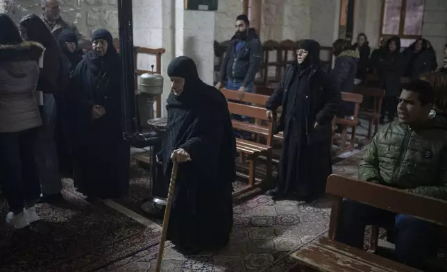 Christians attend the Christmas mass in the Greek Orthodox convent Saint Takla, in Maaloula, some 60 km northern Damascus, Syria, Tuesday, Dec. 24, 2024. (AP Photo/Leo Correa)