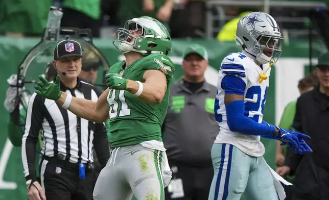 Philadelphia Eagles tight end Grant Calcaterra (81) reacts after making a catch in front of Dallas Cowboys safety Israel Mukuamu (24) during the first half of an NFL football game, Sunday, Dec. 29, 2024, in Philadelphia. (AP Photo/Matt Slocum)