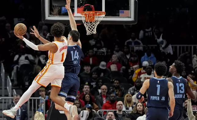 Atlanta Hawks forward Jalen Johnson (1) shoots against Memphis Grizzlies center Zach Edey (14) during the first half of an NBA basketball game, Saturday, Dec. 21, 2024, in Atlanta. (AP Photo/Mike Stewart)