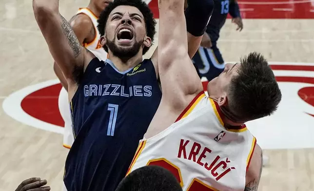 Memphis Grizzlies guard Scotty Pippen Jr. (1) shoots against Atlanta Hawks guard Vit Krejci (27) during the first half of an NBA basketball game, Saturday, Dec. 21, 2024, in Atlanta. (AP Photo/Mike Stewart)