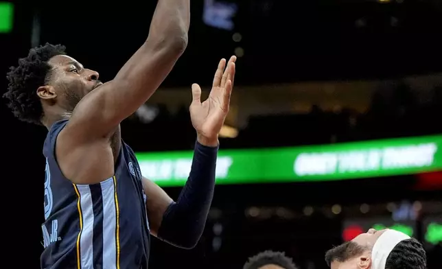 Memphis Grizzlies forward Jaren Jackson Jr. (13) shoots against Atlanta Hawks forward Larry Nance Jr. (22) during the first half of an NBA basketball game, Saturday, Dec. 21, 2024, in Atlanta. (AP Photo/Mike Stewart)