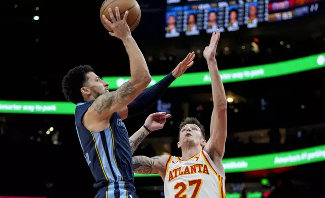 Memphis Grizzlies guard Scotty Pippen Jr. (1) shoots against Atlanta Hawks guard Vit Krejci (27) during the first half of an NBA basketball game, Saturday, Dec. 21, 2024, in Atlanta. (AP Photo/Mike Stewart)