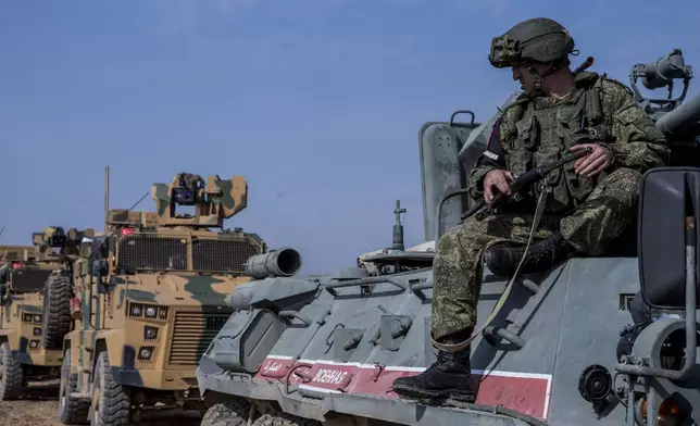 FILE - A Turkish and Russian patrol is seen near the town of Darbasiyah, Syria, Friday, Nov. 1, 2019. (AP Photo/Baderkhan Ahmad, File)