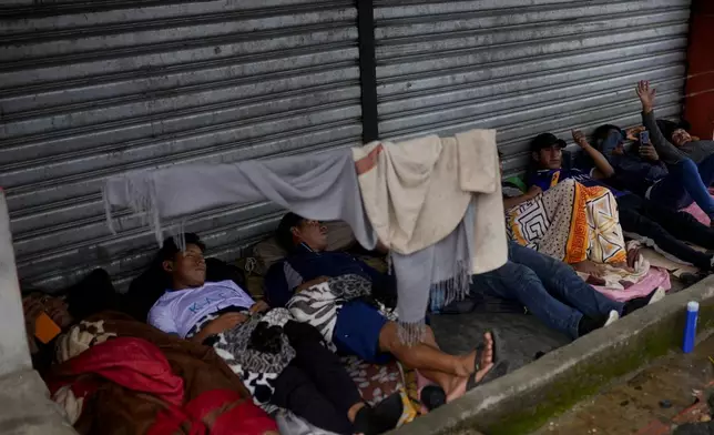 FILE - Supporters of former President Evo Morales rest as they guard the coca growers union where Morales is staying in Lauca N in the Chapare region of Bolivia, Nov. 21, 2024. (AP Photo/Juan Karita, File)