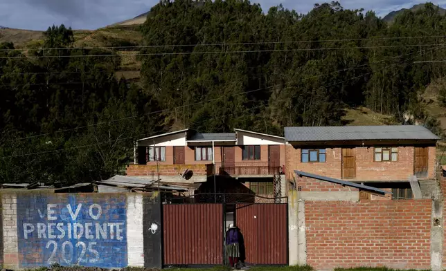 FILE - A mural that reads in Spanish, "Evo President 2025," referring to former President Evo Morales, covers a wall outside a home in Colomi, Bolivia, Nov. 9, 2024. (AP Photo/Juan Karita, File)