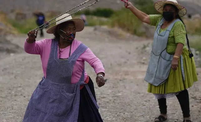 FILE - Protesters practice using slings as they block a road in support of former President Evo Morales in the face of an investigation of his alleged abuse of a minor while in office in Parotani, Bolivia, Oct. 31, 2024. (AP Photo/Juan Karita, File)