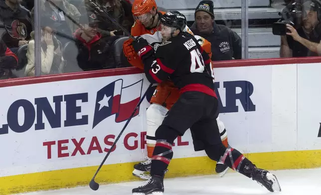 Ottawa Senators' Tyler Kleven collides with Anaheim Ducks' Jacob Trouba along the boardsduring the second period of an NHL hockey game, Wednesday, Dec. 11, 2024 in Ottawa, Ontario. (Adrian Wyld/The Canadian Press via AP)