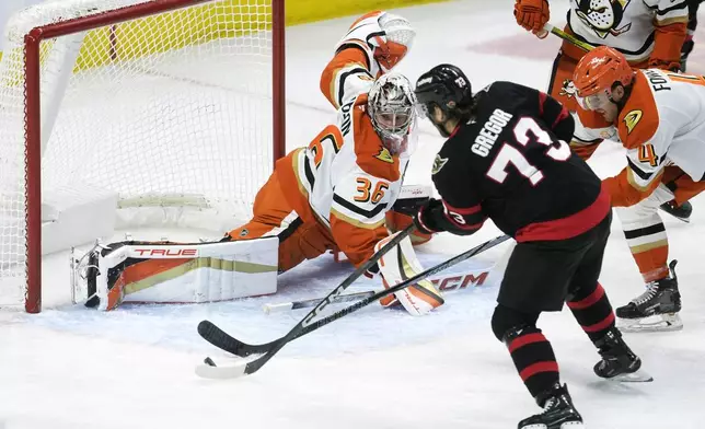 Ottawa Senators' Noah Gregor scores on Anaheim Ducks goaltender John Gibson during the first period of an NHL hockey game, Wednesday, Dec. 11, 2024 in Ottawa, Ontario. (Adrian Wyld/The Canadian Press via AP)