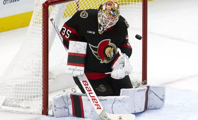 Ottawa Senators goaltender Linus Ullmark stops a shot during the second period of an NHL hockey game against the Anaheim Ducks, Wednesday, Dec. 11, 2024 in Ottawa, Ontario. (Adrian Wyld/The Canadian Press via AP)