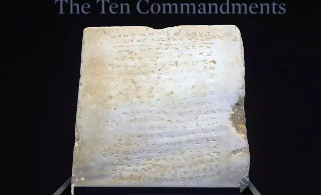 The oldest complete tablet of the Ten Commandments, weighing 115-pounds and approximately 1,500 years old, is displayed at Sotheby's, in New York, Monday, Dec. 9, 2024, where it is to be offered for auction in a single lot sale, Dec, 18, 2024. (AP Photo/Richard Drew)