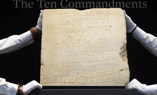 The oldest complete tablet of the Ten Commandments, weighing 115-pounds and approximately 1,500 years old, is displayed at Sotheby's, in New York, Monday, Dec. 9, 2024, where it is to be offered for auction in a single lot sale, Dec, 18, 2024. (AP Photo/Richard Drew)