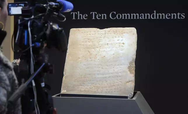 The oldest complete tablet of the Ten Commandments, weighing 115-pounds and approximately 1,500 years old, is displayed at Sotheby's, in New York, Monday, Dec. 9, 2024, where it is to be offered for auction in a single lot sale, Dec, 18, 2024. (AP Photo/Richard Drew)