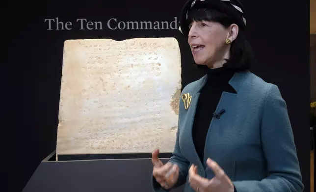 Sharon Liberman Mintz, Sotheby's Judaica Specialist, Books &amp; Manuscripts, discusses the oldest complete tablet of the Ten Commandments, weighing 115-pounds and approximately 1,500 years old, that is displayed at Sotheby's, in New York, Monday, Dec. 9, 2024, where it is to be offered for auction in a single lot sale, Dec, 18, 2024. (AP Photo/Richard Drew)