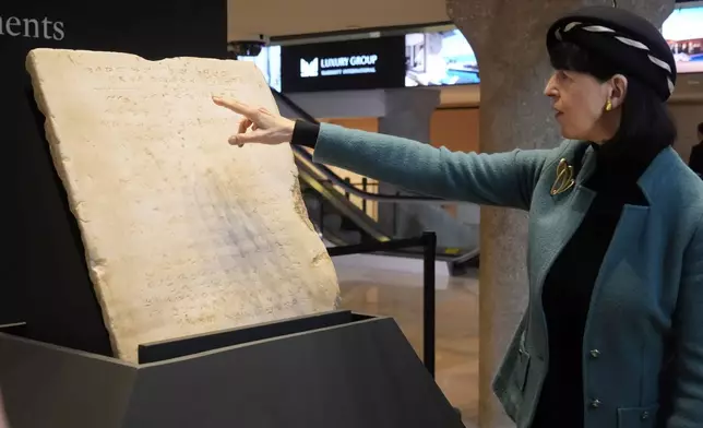 Sharon Liberman Mintz, Sotheby's Judaica Specialist, Books &amp; Manuscripts, discusses the oldest complete tablet of the Ten Commandments, weighing 115-pounds and approximately 1,500 years old, that is displayed at Sotheby's, in New York, Monday, Dec. 9, 2024, where it is to be offered for auction in a single lot sale, Dec, 18, 2024. (AP Photo/Richard Drew)