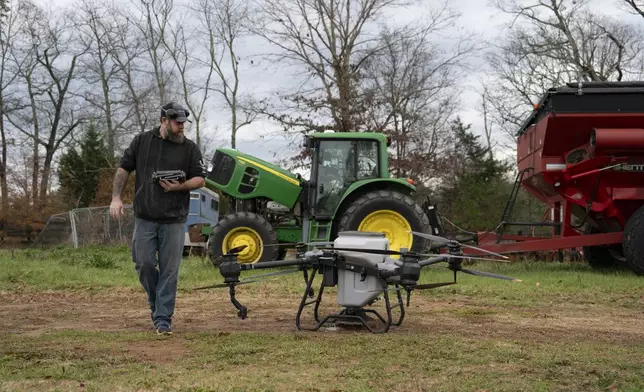 Russell Hedrick prepares a DJI drone to put crop cover on his farm, Tuesday, Dec. 17, 2024, in Hickory, N.C. (AP Photo/Allison Joyce)