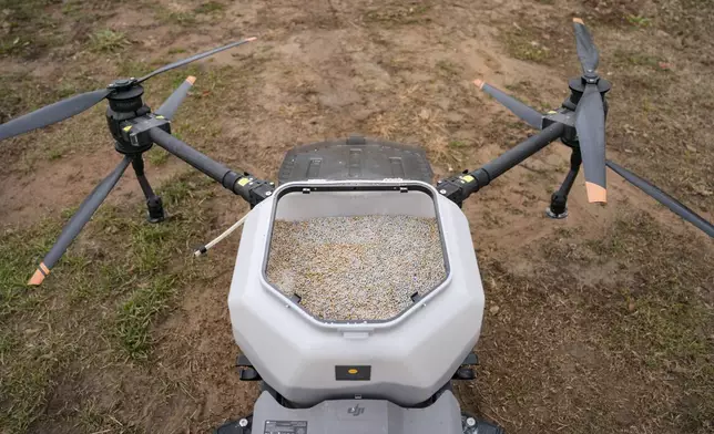 Russell Hedrick uses a DJI drone to put crop cover on his farm, Tuesday, Dec. 17, 2024, in Hickory, N.C. (AP Photo/Allison Joyce)