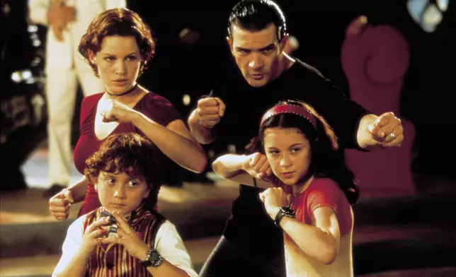 This image released by the Library of Congress shows clockwise from top left, Gina Gugino, Antonio Banderas, Alexa PenaVega and Daryl Sabara in a scene from the 2001 film "Spy Kids." (Spyglass Media Group/Library of Congress via AP)