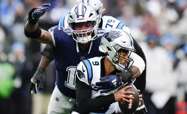 Dallas Cowboys linebacker Micah Parsons sacks Carolina Panthers quarterback Bryce Young during the second half of an NFL football game, Sunday, Dec. 15, 2024, in Charlotte, N.C. (AP Photo/Rusty Jones)
