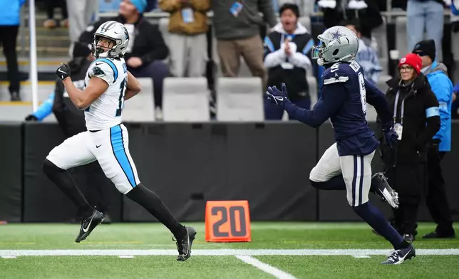 Carolina Panthers wide receiver Jalen Coker (18) runs for a touchdown against the Dallas Cowboys during the first half of an NFL football game, Sunday, Dec. 15, 2024, in Charlotte, N.C. (AP Photo/Jacob Kupferman)