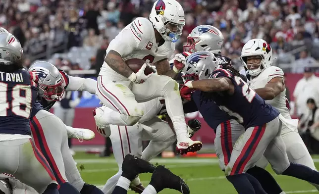 Arizona Cardinals running back James Conner (6) scores a touchdown against the New England Patriots during the second half of an NFL football game, Sunday, Dec. 15, 2024, in Glendale, Ariz. (AP Photo/Ross D. Franklin)