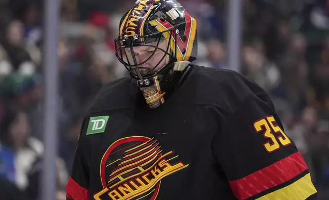 Vancouver Canucks goalie Thatcher Demko skates to the corner during a stoppage in play during the second period of an NHL hockey game against the St. Louis Blues in Vancouver, on Tuesday, Dec. 10, 2024. (Darryl Dyck/The Canadian Press via AP)