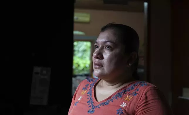 Dalila Santiago, the leader of the Municipal Committee for the Defense of the Common and Public Goods (CMDBCP) and a close friend of slain environmentalist Juan López, sheds tears during an interview in Tocoa, Honduras, Thursday, Dec. 5, 2024. (AP Photo/Moises Castillo)