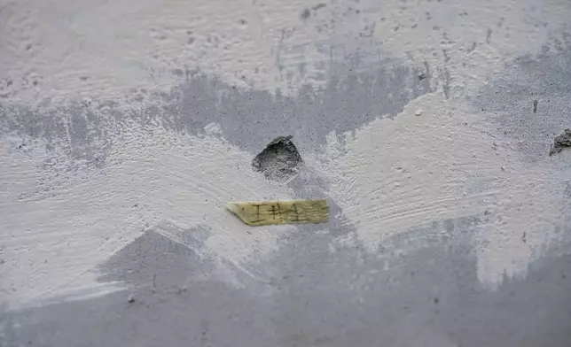 A bullet hole perforates the wall of a church, where environmentalist Juan López was killed, in the Fabio Ochoa neighborhood of Tocoa, Honduras, Friday, Dec. 6, 2024. (AP Photo/Moises Castillo)