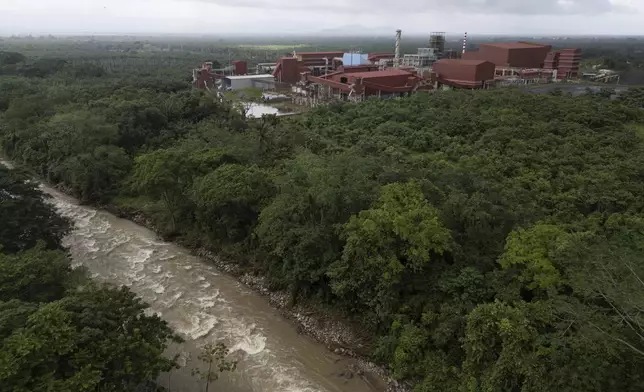 The Guapinol River flows alongside Los Pinares iron oxide mining project in Tocoa, Honduras, Friday, Dec. 6, 2024. (AP Photo/Moises Castillo)