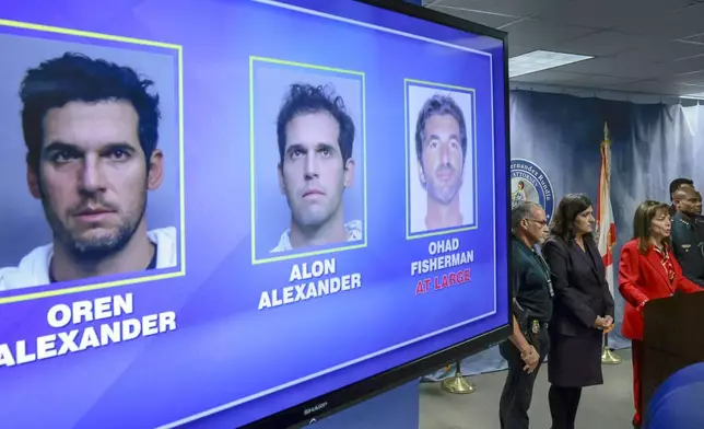 Suspects arrested or at large are displayed during State Attorney Katherine Fernandez Rundle's press conference at the State Attorney's Office, in Miami, Wednesday, Dec. 11, 2024, regarding the arrest of the Alexander twin brothers and suspect at large Ohad Fisherman for their sexual assault allegations in Miami Beach. (Al Diaz/Miami Herald via AP)