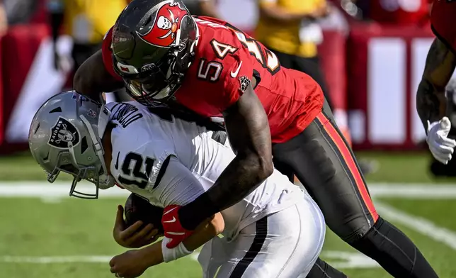 Tampa Bay Buccaneers linebacker Lavonte David (54) sacks Las Vegas Raiders quarterback Aidan O'Connell (12) during the first half of an NFL football game, Sunday, Dec. 8, 2024, in Tampa, Fla. (AP Photo/Jason Behnken)