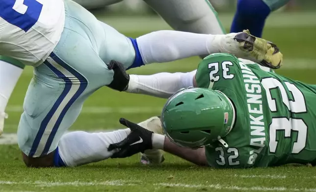 Philadelphia Eagles safety Reed Blankenship, right, grabs at Dallas Cowboys running back Rico Dowdle while tackling him during the second half of an NFL football game, Sunday, Dec. 29, 2024, in Philadelphia. (AP Photo/Matt Slocum)